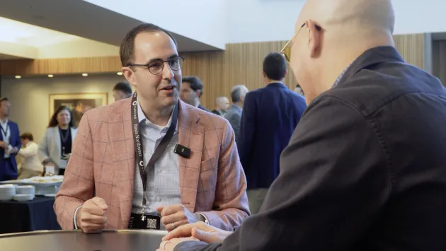 Why ETFs Are the Key to Bringing Wall Street On-Chain Alex Morris smiles while talking with Dave Nadig at Basis Northwest